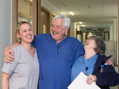 Colleagues laughing in a hospital corridor