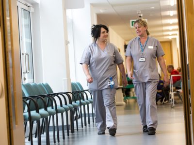 Healthcare professionals walking in a hospital corridor
