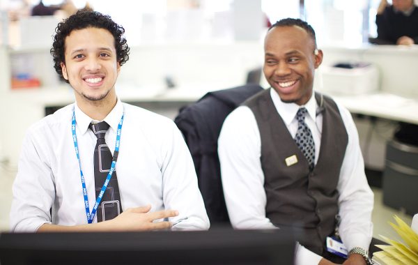 Two staff members at a reception desk