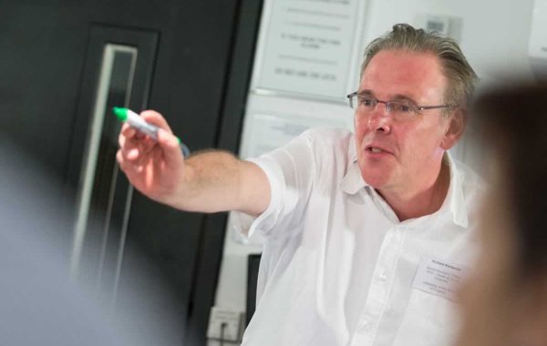 A trainer at a CLAHRC West training course