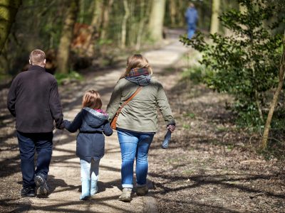 A family walking in the woods