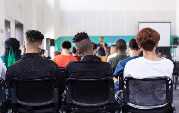 Students sitting on chairs in school