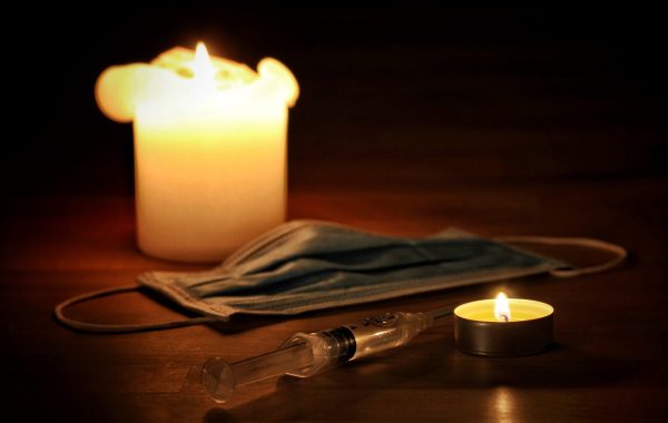 A face mask, candles and syringe