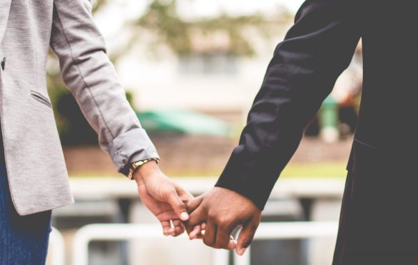 Two people holding hands