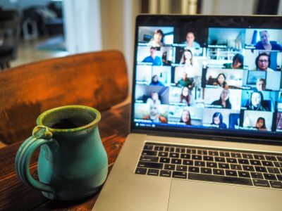A coffee mug in front of an open online meeting