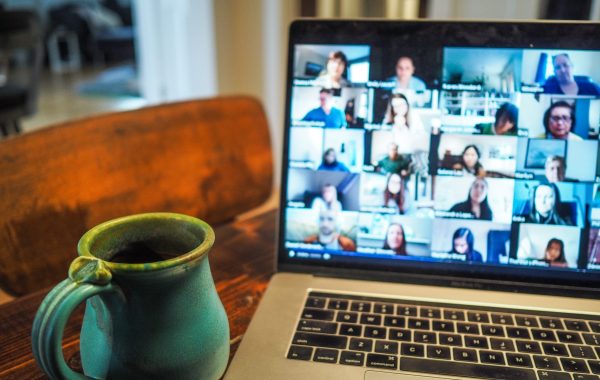 A coffee mug in front of an open online meeting