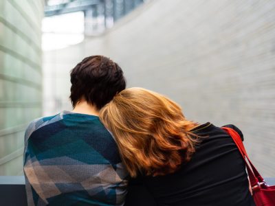 Person rests head on another's shoulder