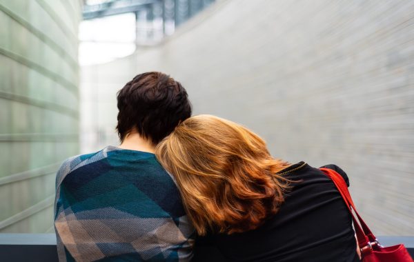 Person rests head on another's shoulder