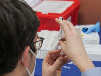 A healthcare professional prepares a COVID-19 vaccination