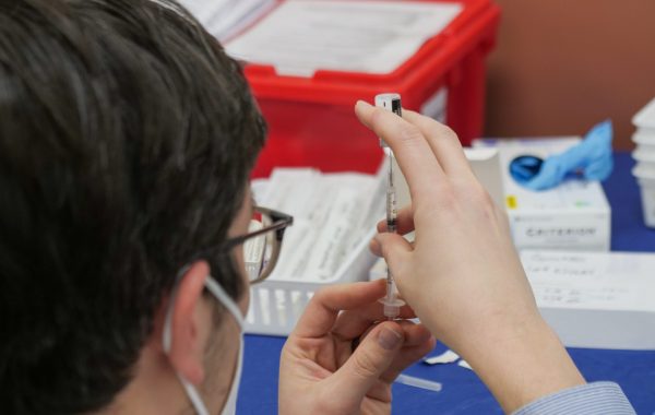 A healthcare professional prepares a COVID-19 vaccination