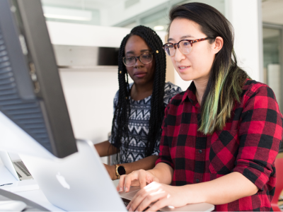 Two people investigate on a computer