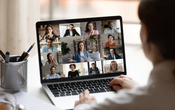 A person uses a laptop to make a Zoom call