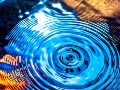 A water drop and ripples on the water's surface