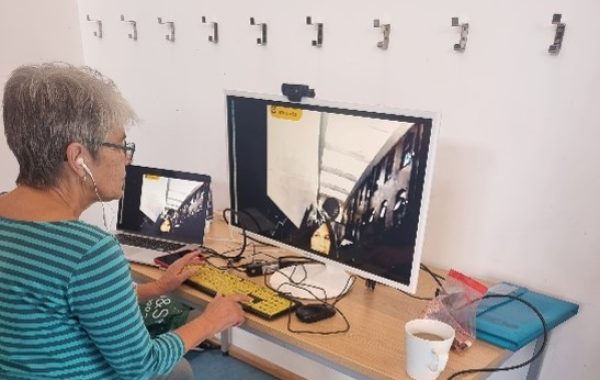 Festival volunteer Wendy operating the Telepresence Robot through a desktop computer