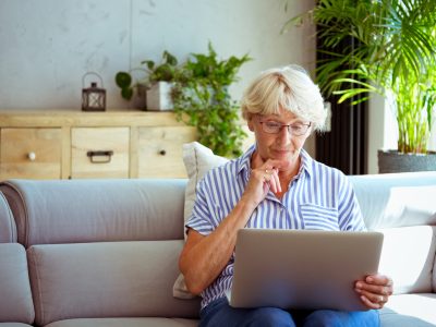An older woman using a laptop