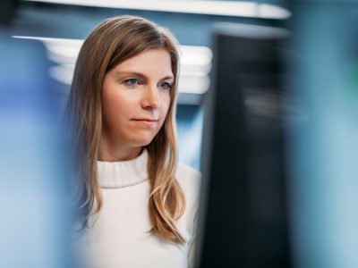 A woman looking at a computer monitor