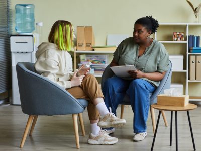 A mental health practitioner is speaking with a young person