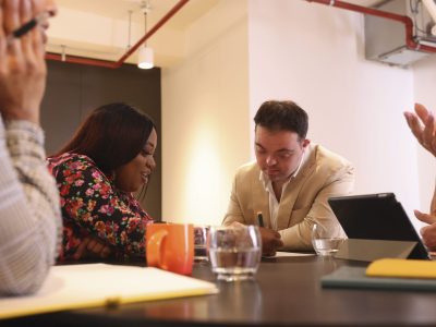 A group of people working around a table together