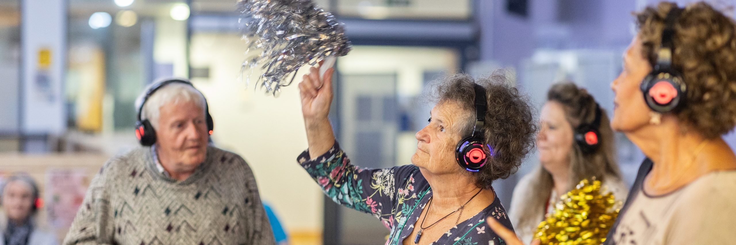People dancing at silent disco. This picture is from The Centre for Ageing Better's Age-positive image library.