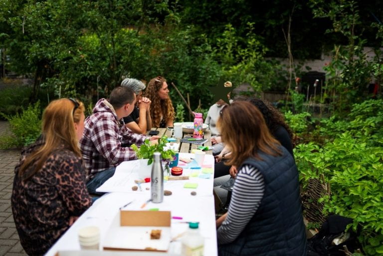 Finalising the Voice of the Voiceless booklet during the final workshop, outside at the Barton-Hill Micro-campus