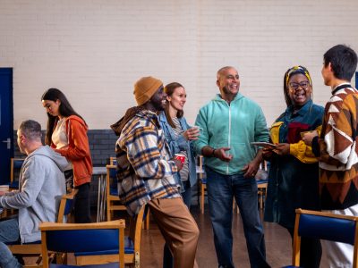 A group of adults talking in a community setting