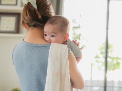 Woman with a baby looking over her shoulder