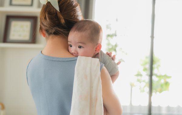 Woman with a baby looking over her shoulder