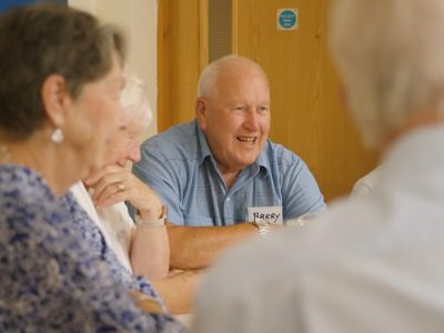 An attendee smiles during a conversation at the LivDem celebration day