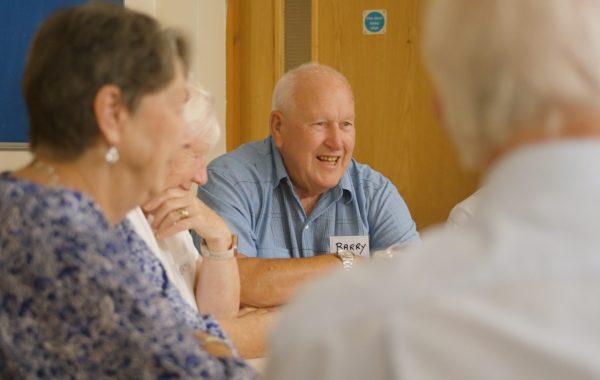An attendee smiles during a conversation at the LivDem celebration day