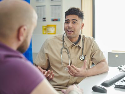 A GP talks to a patient