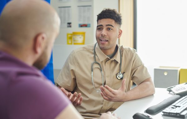 A GP talks to a patient